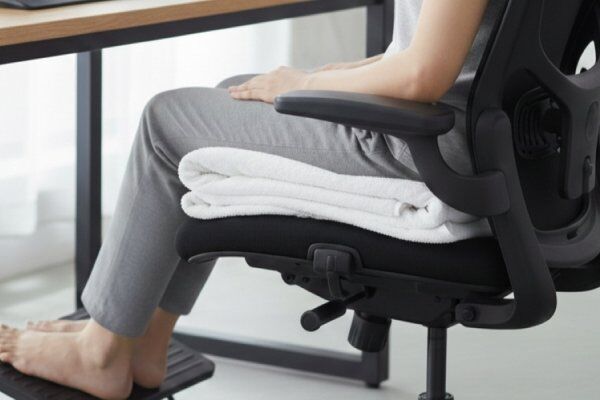 Dicas para reduzir a dor no Cóccix na postura sentada durante a jornada de trabalho.